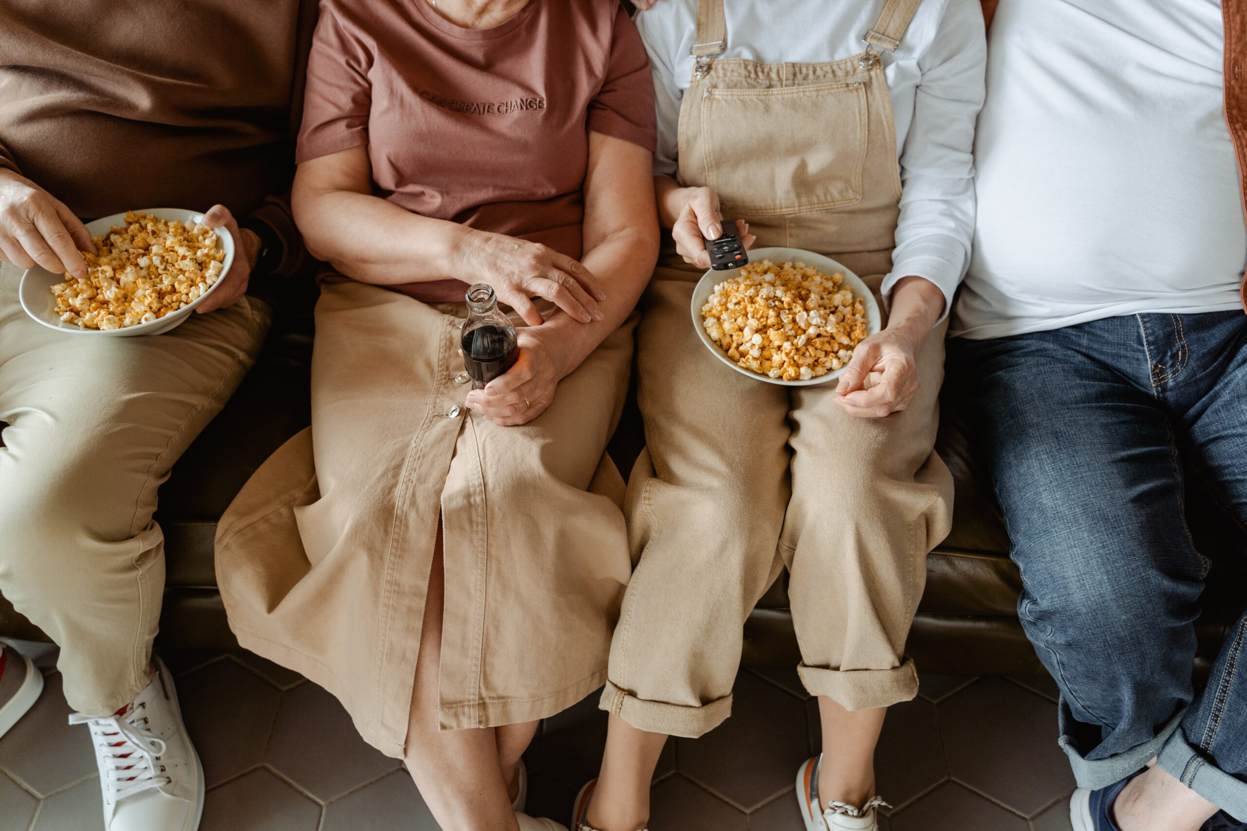 Elderly Individuals Sitting Together with Popcorn