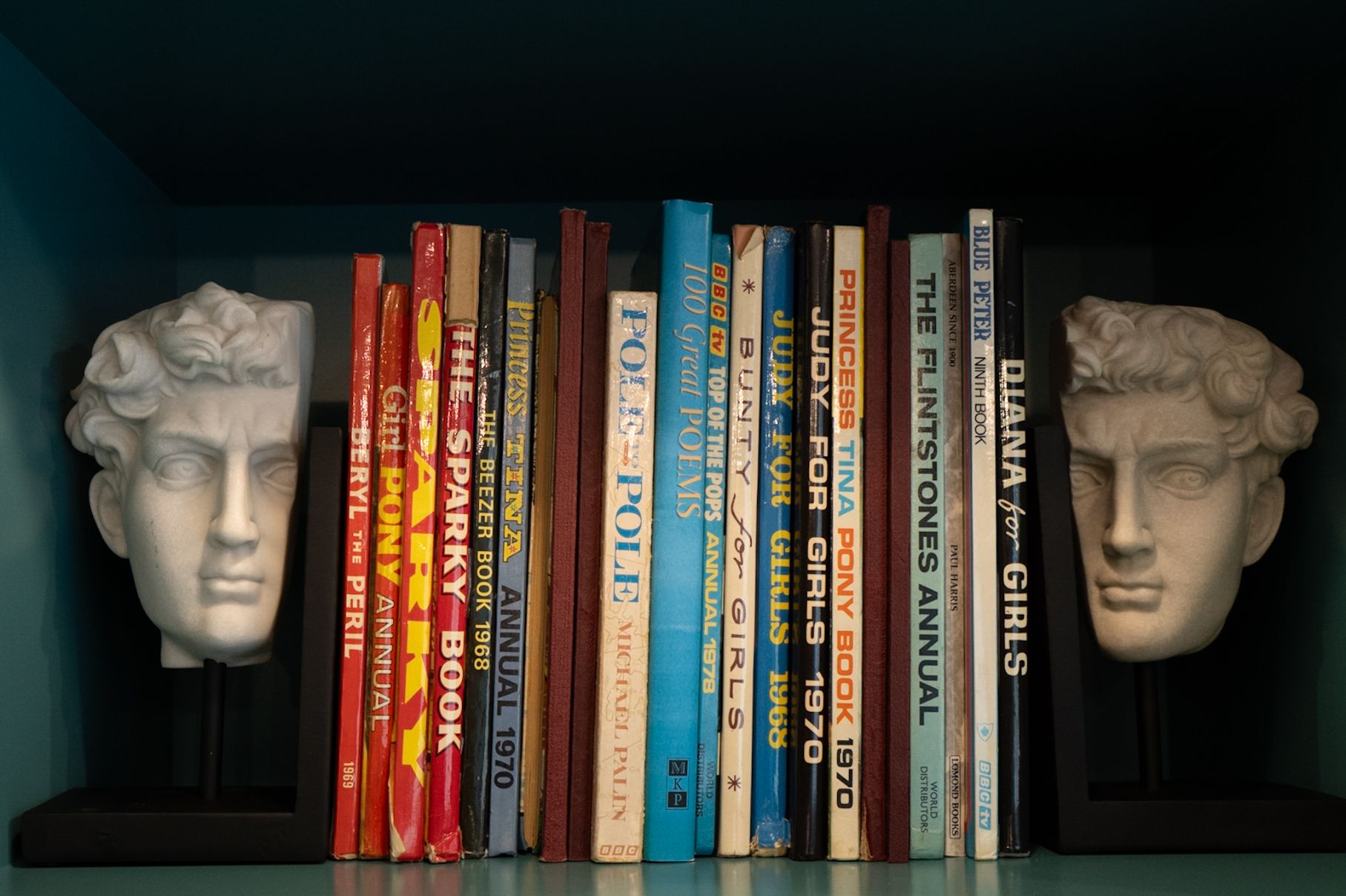 Stack of Books with Statue Heads