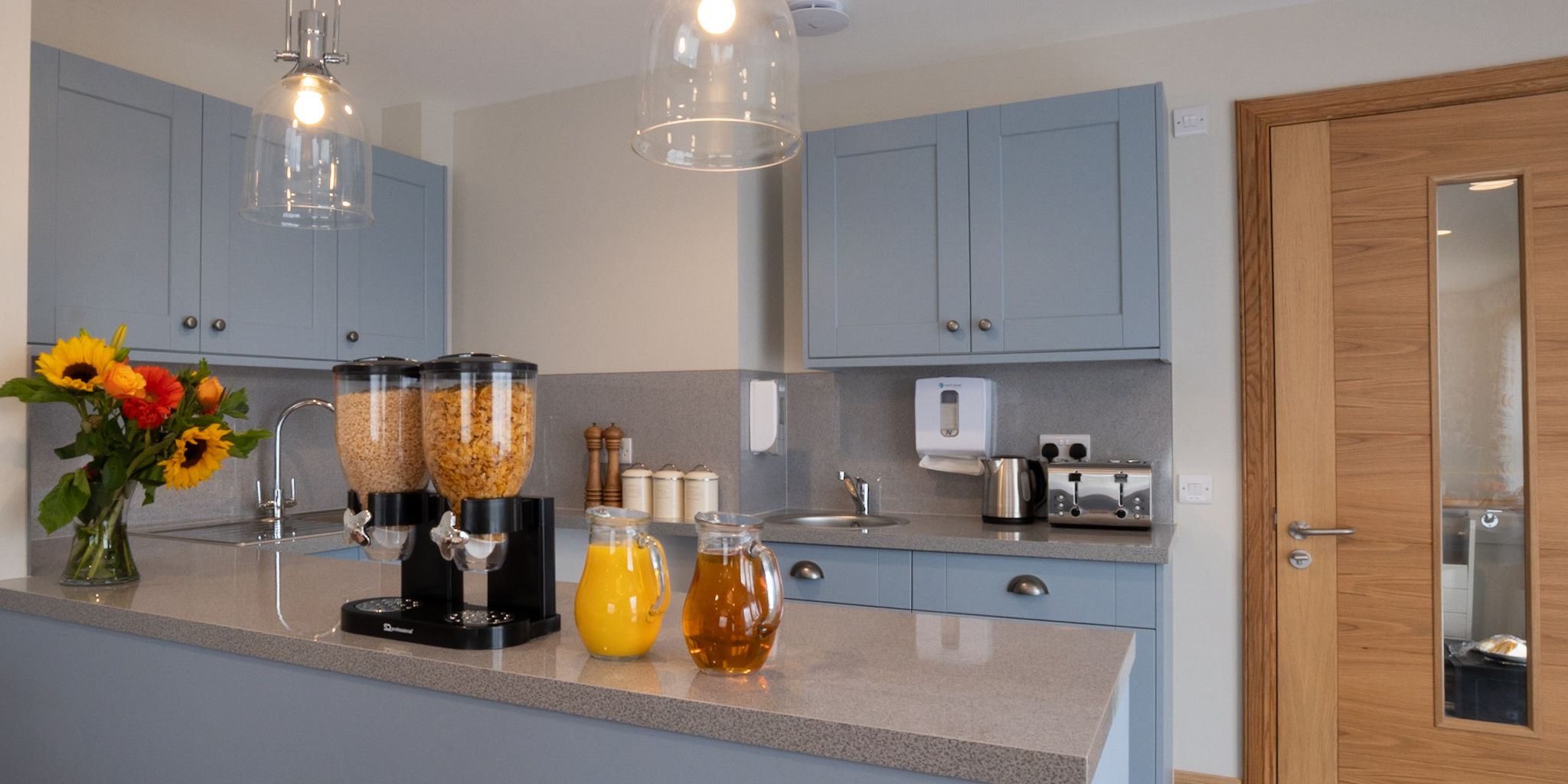 Kitchenette with Cereal Dispensers & Jug of Juices